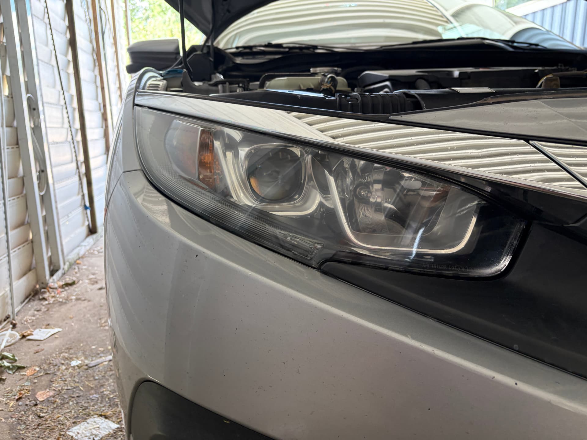 Clear headlight after restoration and ceramic coating — cloudy car headlight before professional restoration and the same headlight after restoration and ceramic coating