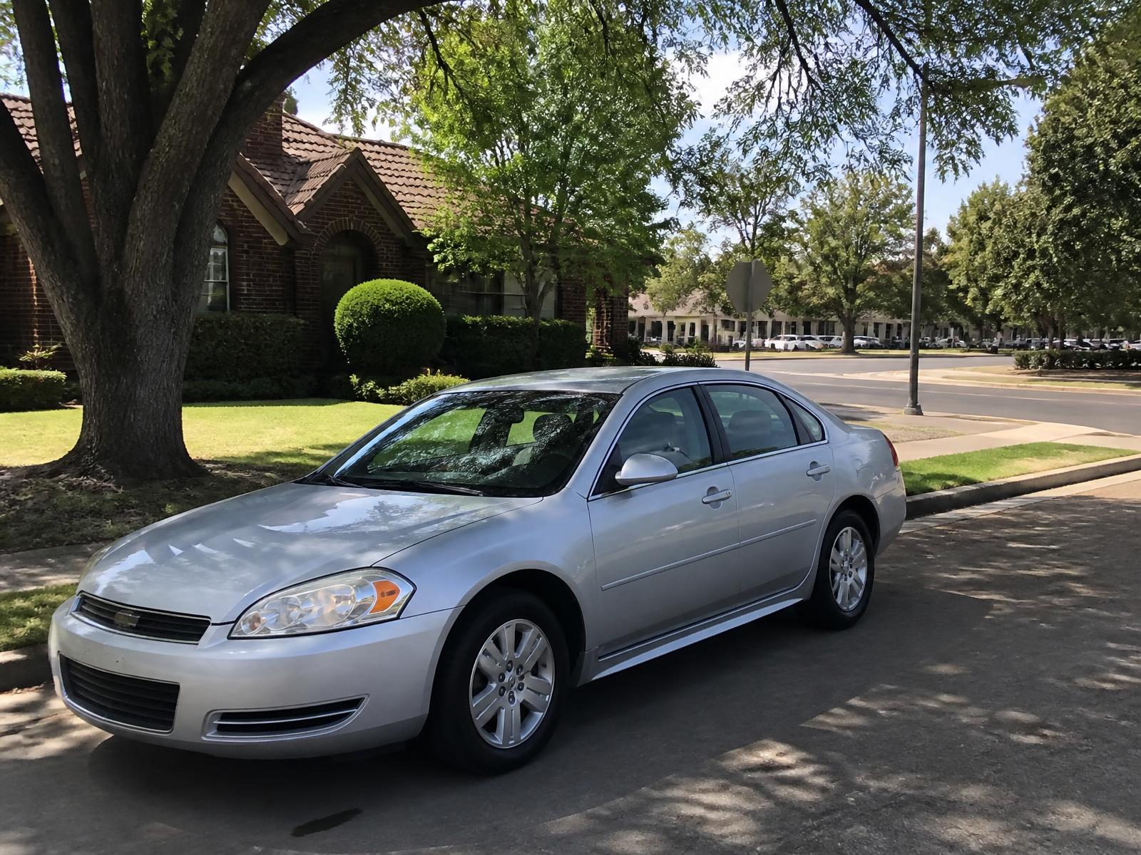 Sedan parked outside in an established Midvale neighborhood near a commercial street during daylight
